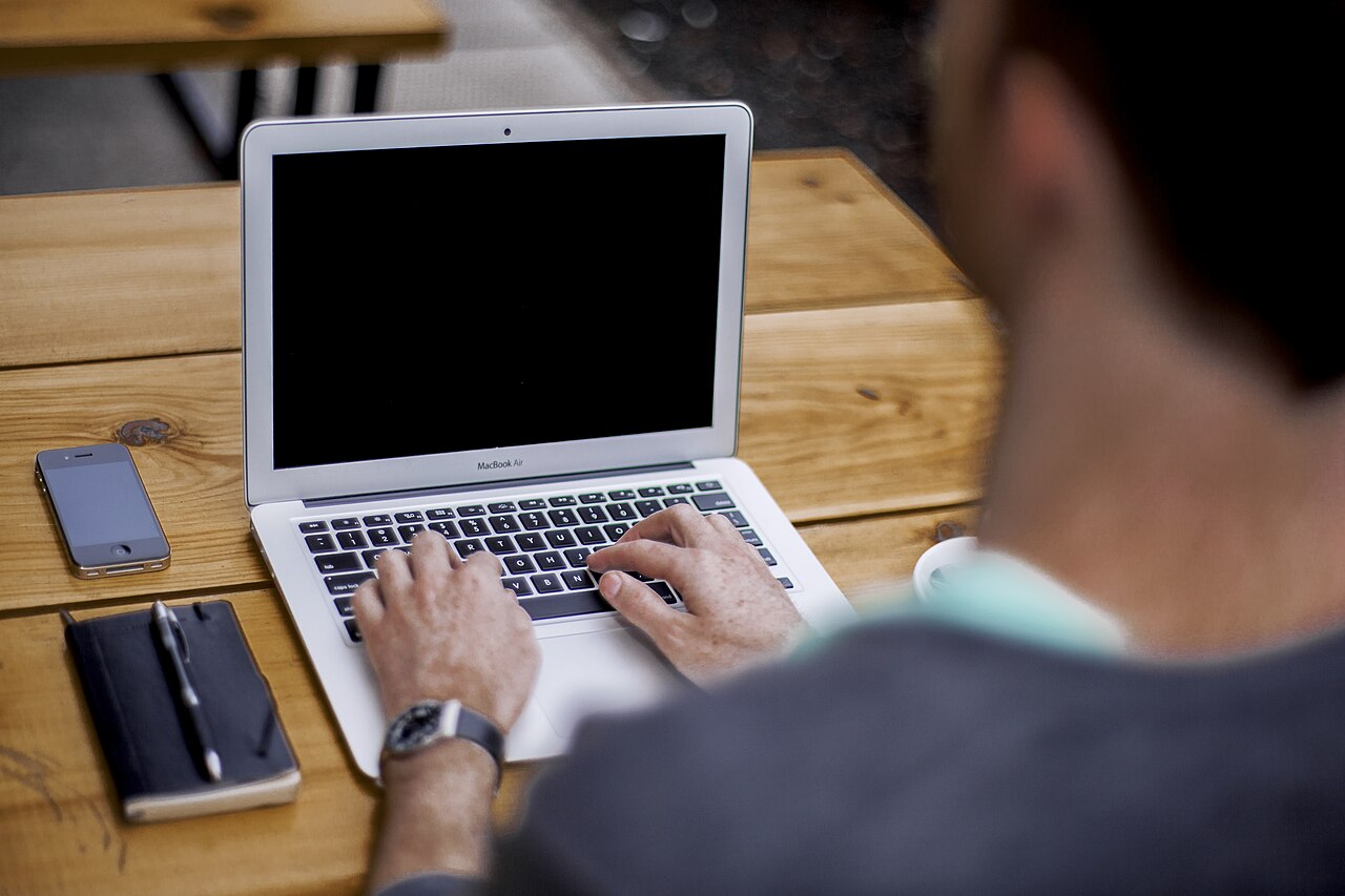 Close view of hands typing on a laptop